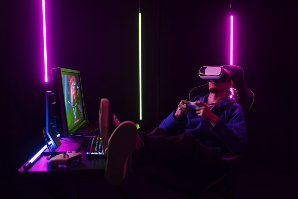 Pessoa com um óculos de realidade virtual. Set up gamer com leds coloridos. 